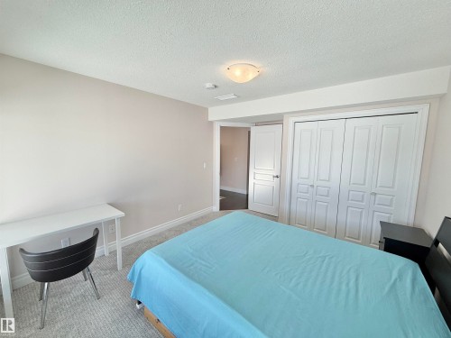 Carpeted bedroom featuring a closet and a textured ceiling - 1019 174 Street, Edmonton, AB - Indoor Photo Showing Bedroom