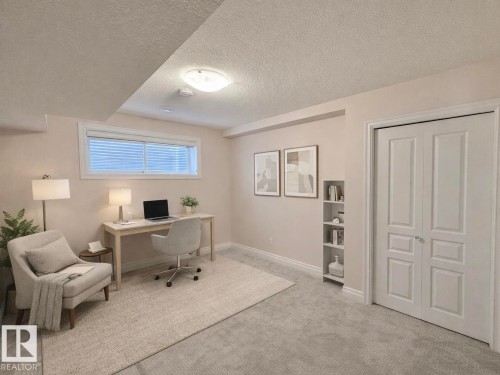 Carpeted office featuring baseboards and a textured ceiling - 1019 174 Street, Edmonton, AB - Indoor