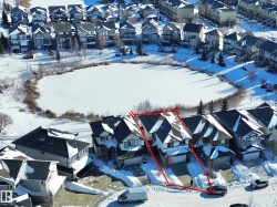 Snowy aerial view featuring a residential view and property boundaries highlighted - 