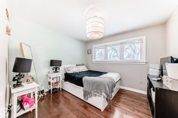 Bedroom featuring wood finished floors and baseboards - 