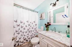 Full bathroom featuring vanity and shower / bathtub combination with curtain - 