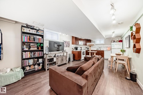 Living room featuring light wood-style flooring and rail lighting - 12332 129 Street, Edmonton, AB - Indoor