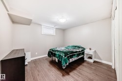 Bedroom featuring wood finished floors and baseboards - 