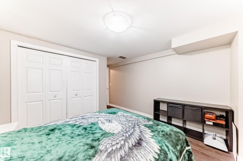 Bedroom with a closet and wood finished floors - 12332 129 Street, Edmonton, AB - Indoor Photo Showing Bedroom