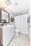 Bathroom with vanity and a shower with shower curtain - 