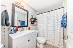 Bathroom featuring vanity, a shower with curtain, and light wood-type flooring - 