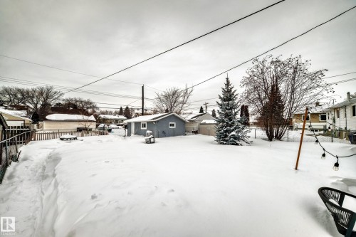 Snowy yard featuring a fenced backyard and a residential view - 12332 129 Street, Edmonton, AB - Outdoor