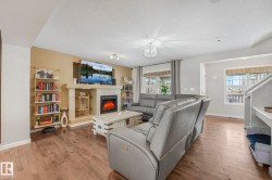 Living area featuring a textured ceiling, hardwood / wood-style flooring, and a fireplace - 