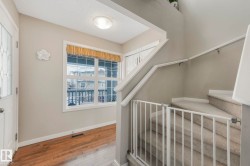 Stairs with wood-type flooring and a textured ceiling - 