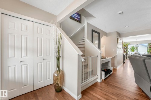 Staircase featuring wood-type flooring and a textured ceiling - 281 Southwick Way, Leduc, AB - Indoor Photo Showing Other Room