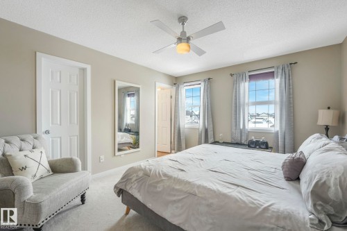 Bedroom featuring carpet floors, a textured ceiling, and ceiling fan - 281 Southwick Way, Leduc, AB - Indoor Photo Showing Bedroom