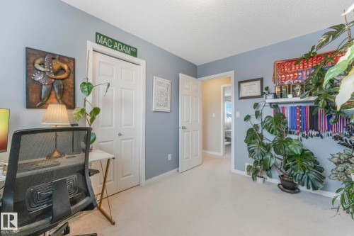 Office with a textured ceiling and light colored carpet - 281 Southwick Way, Leduc, AB - Indoor