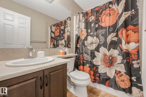 Full bathroom with vanity, curtained shower, and a textured ceiling - 281 Southwick Way, Leduc, AB - Indoor Photo Showing Bathroom