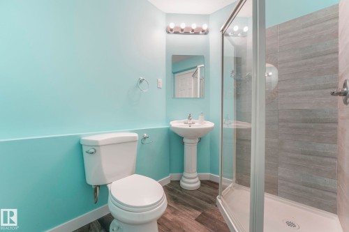 Full bathroom featuring a shower stall and dark wood-style floors - 281 Southwick Way, Leduc, AB - Indoor Photo Showing Bathroom