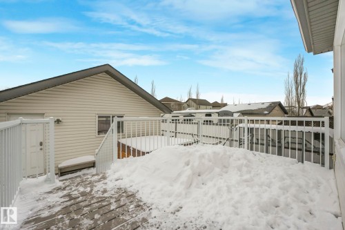 View of side of home featuring a wooden deck and a residential view - 281 Southwick Way, Leduc, AB - Outdoor