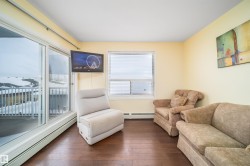 Sitting room featuring a baseboard radiator and wood-type flooring - 