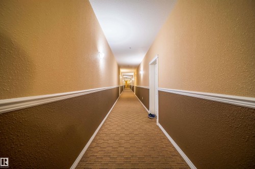Hall with a textured wall and carpet flooring - 211 4310 33 Street, Stony Plain, AB - Indoor Photo Showing Other Room