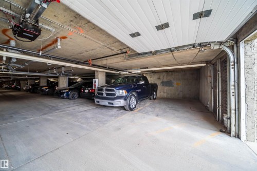 Parking garage featuring a garage door opener - 211 4310 33 Street, Stony Plain, AB - Indoor Photo Showing Garage