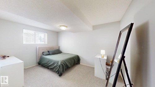 Bedroom with a textured ceiling and light colored carpet - 17010 84 Street, Edmonton, AB - Indoor Photo Showing Bedroom