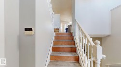 Stairway featuring wood finished floors - 