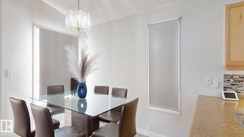Dining space with a chandelier and a textured ceiling - 17010 84 Street, Edmonton, AB - Indoor Photo Showing Dining Room
