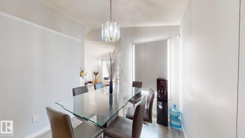 Dining space with lofted ceiling, suspended lighting, and light wood-type flooring - 17010 84 Street, Edmonton, AB - Indoor Photo Showing Dining Room