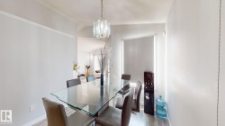 Dining space with lofted ceiling, suspended lighting, and light wood-type flooring - 