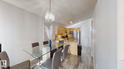 Dining area featuring lofted ceiling, light wood-type flooring, and hanging lights - 