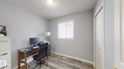 Office featuring light wood-style floors and a textured ceiling - 