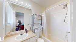 Ensuite bathroom featuring vanity and shower / bathtub combination with curtain - 