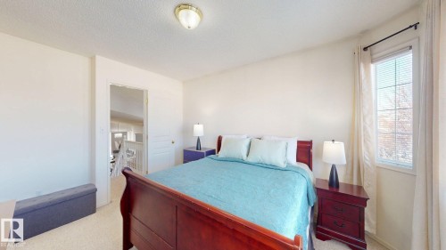Bedroom featuring a textured ceiling and light colored carpet - 17010 84 Street, Edmonton, AB - Indoor Photo Showing Bedroom