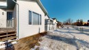 View of property exterior featuring a wooden deck and a residential view - 17010 84 Street, Edmonton, AB  - Outdoor 