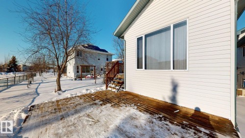 Snow covered property featuring a wooden deck - 17010 84 Street, Edmonton, AB - Outdoor With Deck Patio Veranda With Exterior
