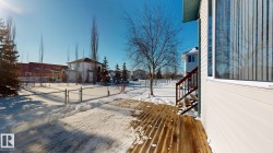 Yard layered in snow featuring a residential view and a gate - 