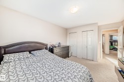 Bedroom with light carpet and two closets - 