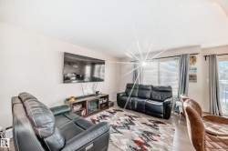 Living area with wood finished floors and a textured ceiling - 