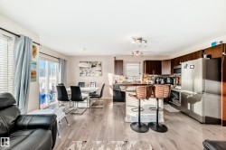 Kitchen with appliances with stainless steel finishes, dark brown cabinets, healthy amount of natural light, and dark countertops - 