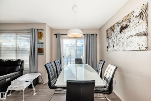 Dining room with healthy amount of natural light and wood finished floors - 1285 Cunningham Drive, Edmonton, AB - Indoor Photo Showing Dining Room