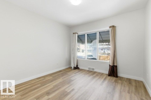 Spare room featuring light wood-style flooring and baseboards - 10704 96 St Nw, Edmonton, AB - Indoor Photo Showing Other Room