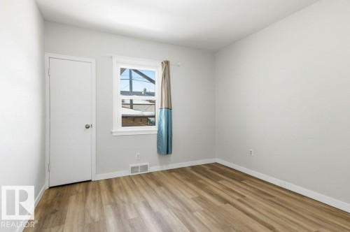 Unfurnished room with light wood-type flooring and baseboards - 10704 96 St Nw, Edmonton, AB - Indoor Photo Showing Other Room