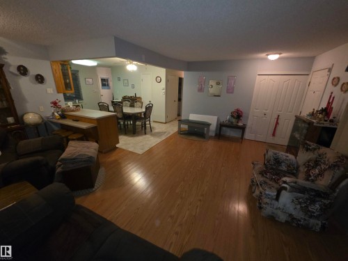 Living area with wood-type flooring and a textured ceiling - 4400 45 Avenue, Stony Plain, AB - Indoor Photo Showing Living Room