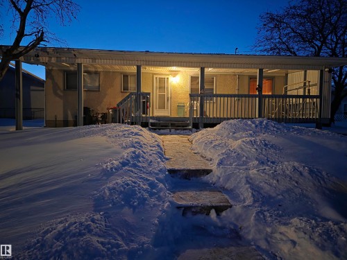 View of front of property with stucco siding and a porch - 4400 45 Avenue, Stony Plain, AB - Outdoor With Deck Patio Veranda