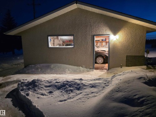Property exterior at twilight featuring stucco siding - 4400 45 Avenue, Stony Plain, AB - Outdoor