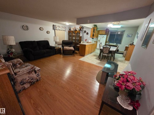 Living room featuring light wood-style floors and a ceiling fan - 4400 45 Avenue, Stony Plain, AB - Indoor Photo Showing Living Room