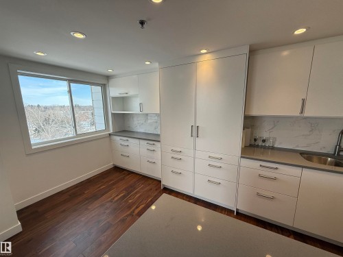 Kitchen featuring white cabinets, open shelves, modern cabinets, recessed lighting, and dark wood-type flooring - 605 8728 Gateway Boulevard, Edmonton, AB - Indoor Photo Showing Kitchen