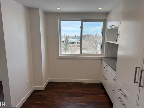 Unfurnished dining area with dark wood-style flooring and recessed lighting - 605 8728 Gateway Boulevard, Edmonton, AB - Indoor Photo Showing Other Room