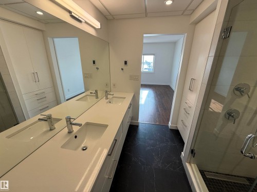 Full bath featuring a shower stall, double vanity, and recessed lighting - 605 8728 Gateway Boulevard, Edmonton, AB - Indoor Photo Showing Bathroom