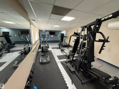 Exercise room featuring a drop ceiling - 605 8728 Gateway Boulevard, Edmonton, AB - Indoor Photo Showing Gym Room
