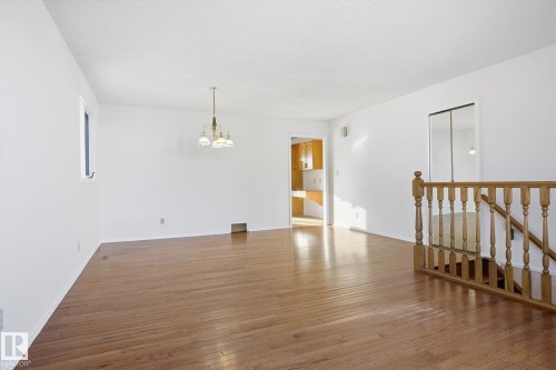 Empty room featuring hardwood / wood-style floors and hanging lights - 17816 94 Street, Edmonton, AB - Indoor Photo Showing Other Room