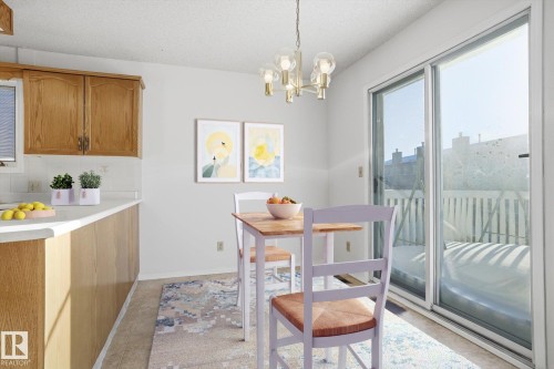 Dining space with suspended lighting and a textured ceiling - 17816 94 Street, Edmonton, AB - Indoor Photo Showing Dining Room